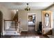 Inviting entryway featuring hardwood floors, a staircase, and access to the kitchen at 5682 N Michigan Rd, Fairland, IN 46126