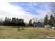 A picturesque view of the home and shed, nestled amongst mature trees at 5682 N Michigan Rd, Fairland, IN 46126