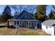 A charming house showcases dormer windows and a cozy porch, set on a well-maintained lawn at 5682 N Michigan Rd, Fairland, IN 46126
