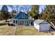 Charming blue two-story home with white trim and detached garage in an expansive yard at 5682 N Michigan Rd, Fairland, IN 46126