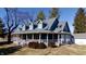 Charming home showcasing a covered porch, dormer windows, and well-manicured landscaping at 5682 N Michigan Rd, Fairland, IN 46126