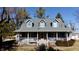 Charming home featuring a covered porch, three dormer windows, and light blue siding at 5682 N Michigan Rd, Fairland, IN 46126