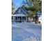 Charming two-story home with a welcoming covered porch in a snow covered yard at 5682 N Michigan Rd, Fairland, IN 46126