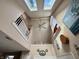 Bright foyer featuring natural light from skylights and a beautiful staircase at 5682 N Michigan Rd, Fairland, IN 46126
