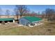 Large outbuilding featuring a drive-in bay and covered patio, providing plenty of storage and work space at 5682 N Michigan Rd, Fairland, IN 46126