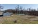 Large outbuilding with a pond, surrounded by mature trees in a sprawling backyard at 5682 N Michigan Rd, Fairland, IN 46126