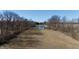 Aerial view of a pond and a long yard and outbuildings bordered by trees at 5682 N Michigan Rd, Fairland, IN 46126