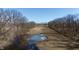 Aerial view of a partially frozen pond and tree-lined field at 5682 N Michigan Rd, Fairland, IN 46126