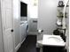 Modern bathroom with dark vanity, white sink, and laundry area at 7571 S County Road 825 E, Plainfield, IN 46168
