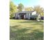 Beautiful ranch home with gray brick exterior and landscaped lawn at 7571 S County Road 825 E, Plainfield, IN 46168