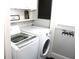 Bright laundry room features washer, dryer, and shelf at 7571 S County Road 825 E, Plainfield, IN 46168