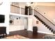 Open living area with loft, hardwood floors, and a wooden staircase at 7571 S County Road 825 E, Plainfield, IN 46168