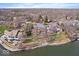 Expansive waterfront homes boast lush landscaping and serene lake views from an aerial perspective at 10901 Brigantine Dr, Indianapolis, IN 46256