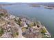 Stunning aerial view showcases the lakeside homes surrounded by mature trees and glistening water at 10901 Brigantine Dr, Indianapolis, IN 46256