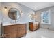 Double vanity bathroom with marble floors and large mirrors at 10901 Brigantine Dr, Indianapolis, IN 46256