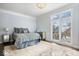Bright bedroom with a queen-size bed and large windows at 10901 Brigantine Dr, Indianapolis, IN 46256