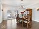 Elegant dining room with hardwood floors, chandelier, and classic wooden furnishings at 10901 Brigantine Dr, Indianapolis, IN 46256