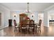 Elegant dining room with hardwood floors, chandelier, and classic wooden furnishings at 10901 Brigantine Dr, Indianapolis, IN 46256