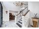 Elegant entryway with marble floors, staircase, and chandelier at 10901 Brigantine Dr, Indianapolis, IN 46256