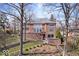 Exterior of house showing the terraced landscaping and mature trees at 10901 Brigantine Dr, Indianapolis, IN 46256