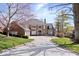 Beautiful brick home featuring a circular driveway and well-manicured front lawn at 10901 Brigantine Dr, Indianapolis, IN 46256