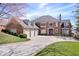 A stately brick home with a spacious three-car garage and a well-maintained lawn at 10901 Brigantine Dr, Indianapolis, IN 46256