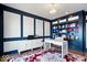 Spacious home office with built-in shelves, a lake view, and navy blue accent wall at 10901 Brigantine Dr, Indianapolis, IN 46256