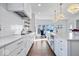 White kitchen with marble countertops and stainless steel appliances at 10901 Brigantine Dr, Indianapolis, IN 46256