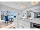 Kitchen with white cabinets, quartz countertops, and a gold faucet at 10901 Brigantine Dr, Indianapolis, IN 46256