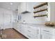 Modern kitchen with white cabinets and gold hardware at 10901 Brigantine Dr, Indianapolis, IN 46256