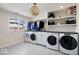 Bright laundry room with washer, dryer and storage at 10901 Brigantine Dr, Indianapolis, IN 46256