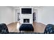Living room with hardwood floors, fireplace, and lake view at 10901 Brigantine Dr, Indianapolis, IN 46256