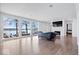 Spacious living room with hardwood floors, fireplace, and lake views at 10901 Brigantine Dr, Indianapolis, IN 46256
