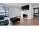 Living room with hardwood floors, fireplace, and lake view at 10901 Brigantine Dr, Indianapolis, IN 46256