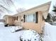 Tan brick ranch house with snow covered yard at 1314 Chester St, Anderson, IN 46012