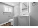 Modern bathroom with gray vanity and a large mirror at 1430 St Paul St, Indianapolis, IN 46203
