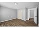 Gray walls, wood floors, and access to hallway at 1430 St Paul St, Indianapolis, IN 46203