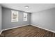 Gray walls, wood floors, and two windows at 1430 St Paul St, Indianapolis, IN 46203