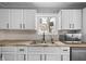 Kitchen features white cabinets, butcher block countertops and stainless steel appliances at 1430 St Paul St, Indianapolis, IN 46203