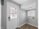 Bright laundry room with white door and vinyl flooring at 1430 St Paul St, Indianapolis, IN 46203
