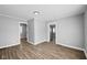 Gray walls and wood floors with access to other rooms at 1430 St Paul St, Indianapolis, IN 46203