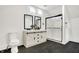 Spa-like bathroom with double vanity, walk-in shower, and dark tile floors at 1745 S Talbott St, Indianapolis, IN 46225