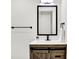 Small bathroom with wood vanity and black framed mirror at 1745 S Talbott St, Indianapolis, IN 46225