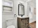 Bathroom with wood vanity, black accents, and window at 1745 S Talbott St, Indianapolis, IN 46225