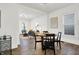 Open concept dining area with round table and chairs, hardwood floors, and living room view at 1745 S Talbott St, Indianapolis, IN 46225