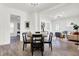 Open concept dining area with round table and chairs, hardwood floors, and living room view at 1745 S Talbott St, Indianapolis, IN 46225