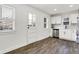 Modern kitchen with white cabinets, wood flooring, and back door access at 1745 S Talbott St, Indianapolis, IN 46225