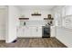 Modern kitchen with white cabinets, wood flooring, and wine fridge at 1745 S Talbott St, Indianapolis, IN 46225