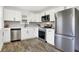 Modern kitchen with white cabinets, stainless steel appliances, and wood flooring at 1745 S Talbott St, Indianapolis, IN 46225