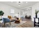 Open concept living room and dining area with hardwood floors and modern lighting at 1745 S Talbott St, Indianapolis, IN 46225